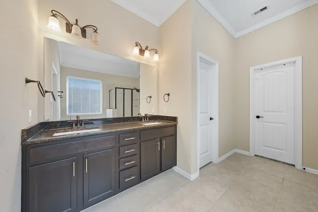 a spacious bathroom with a granite countertop sink a mirror and a