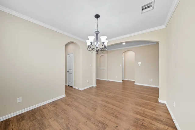 a view of a chandelier in big room and chandelier