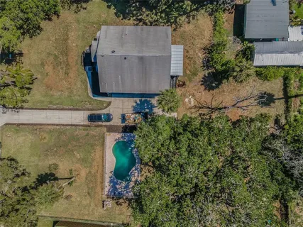 an aerial view of a house with a yard