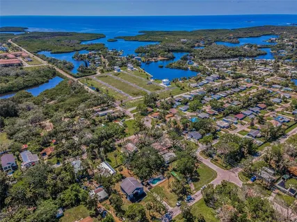 an aerial view of a house with a yard basket ball court and outdoor seating