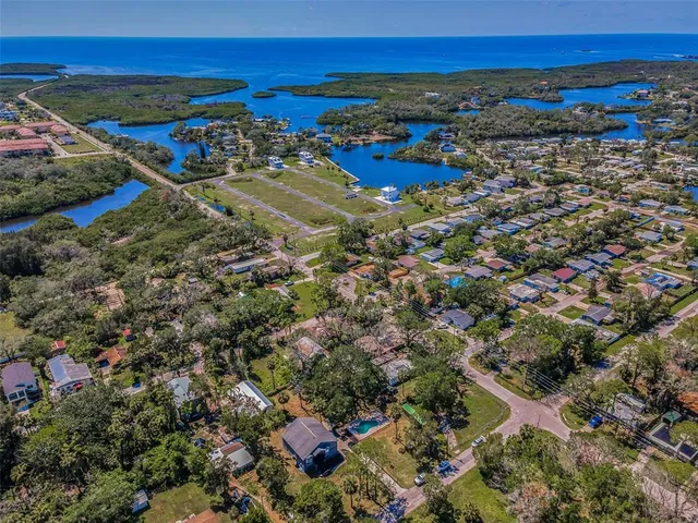 an aerial view of a house with a yard basket ball court and outdoor seating