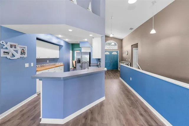 a kitchen with sink a microwave and cabinets
