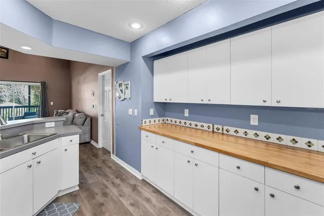 a kitchen with stainless steel appliances granite countertop a refrigerator a stove top oven a sink and dishwasher