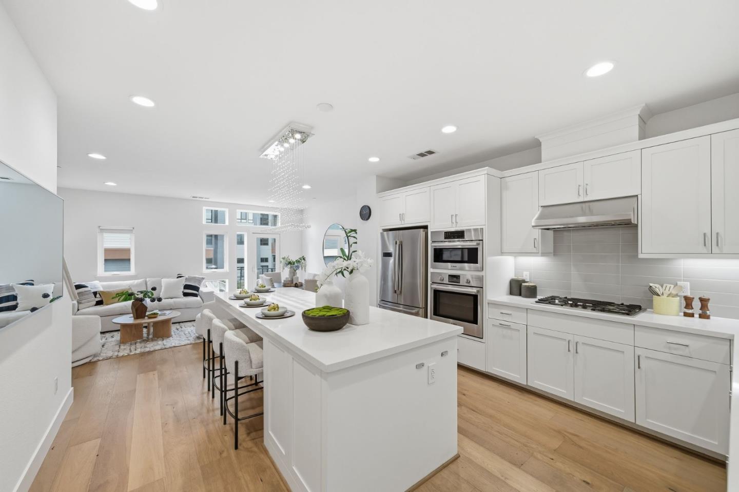 a kitchen with white cabinets and stainless steel appliances