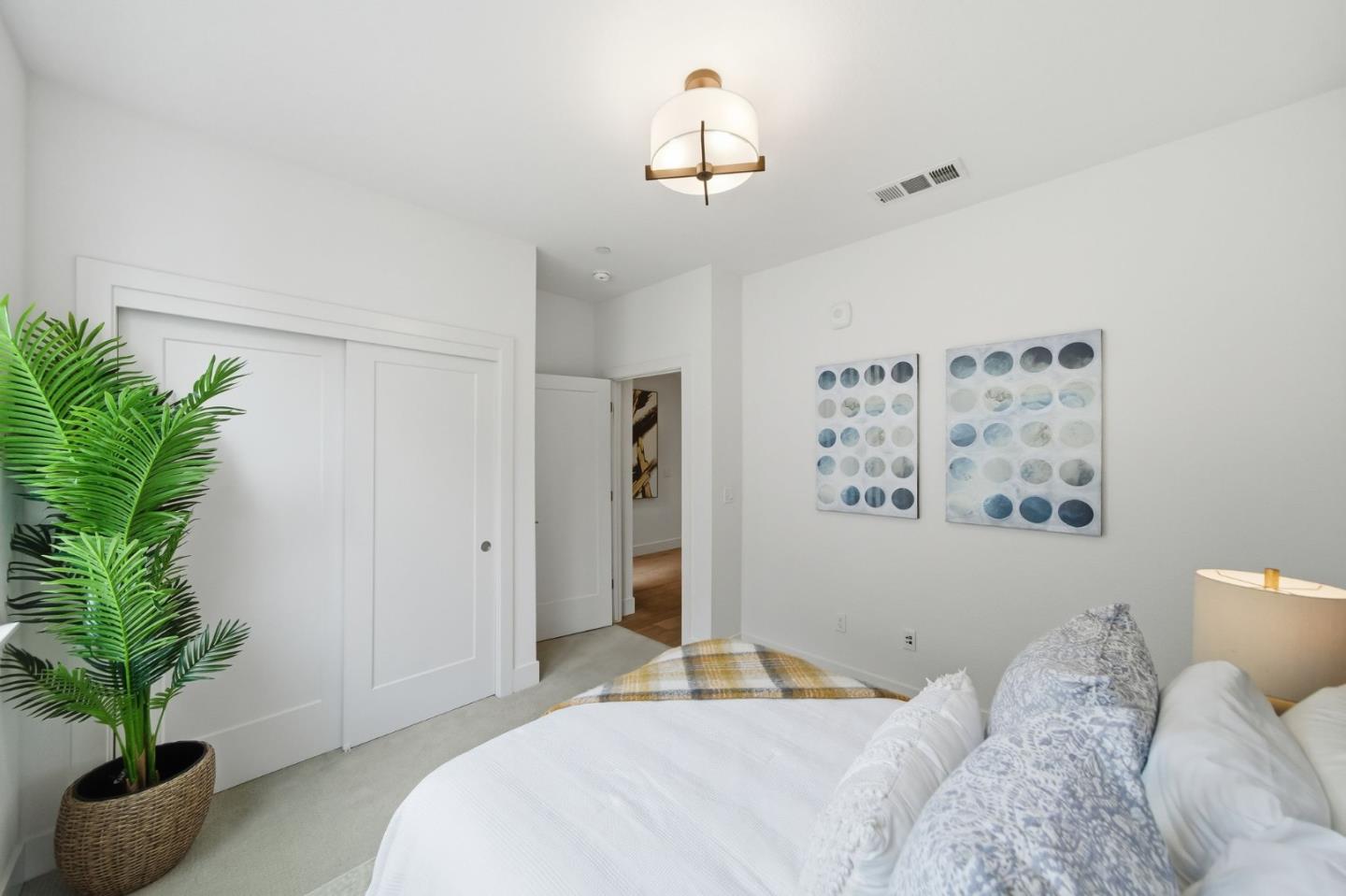 39124 Memorial Street Fremont, CA 94538 - Photo 23 of 40 a bedroom with a large bed and a potted plant