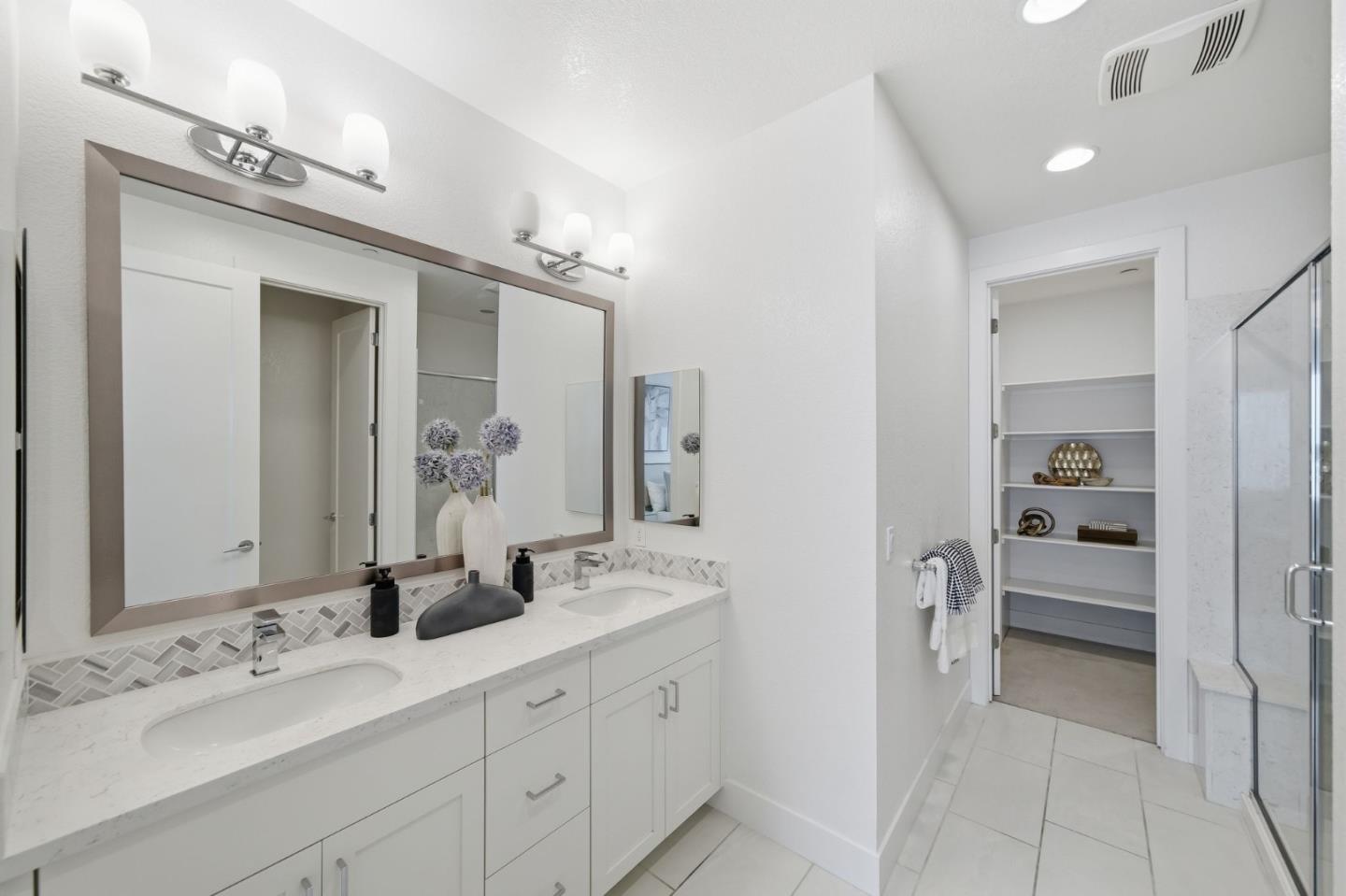 39124 Memorial Street Fremont, CA 94538 - Photo 31 of 40 a spacious bathroom with a double vanity sink and a mirror