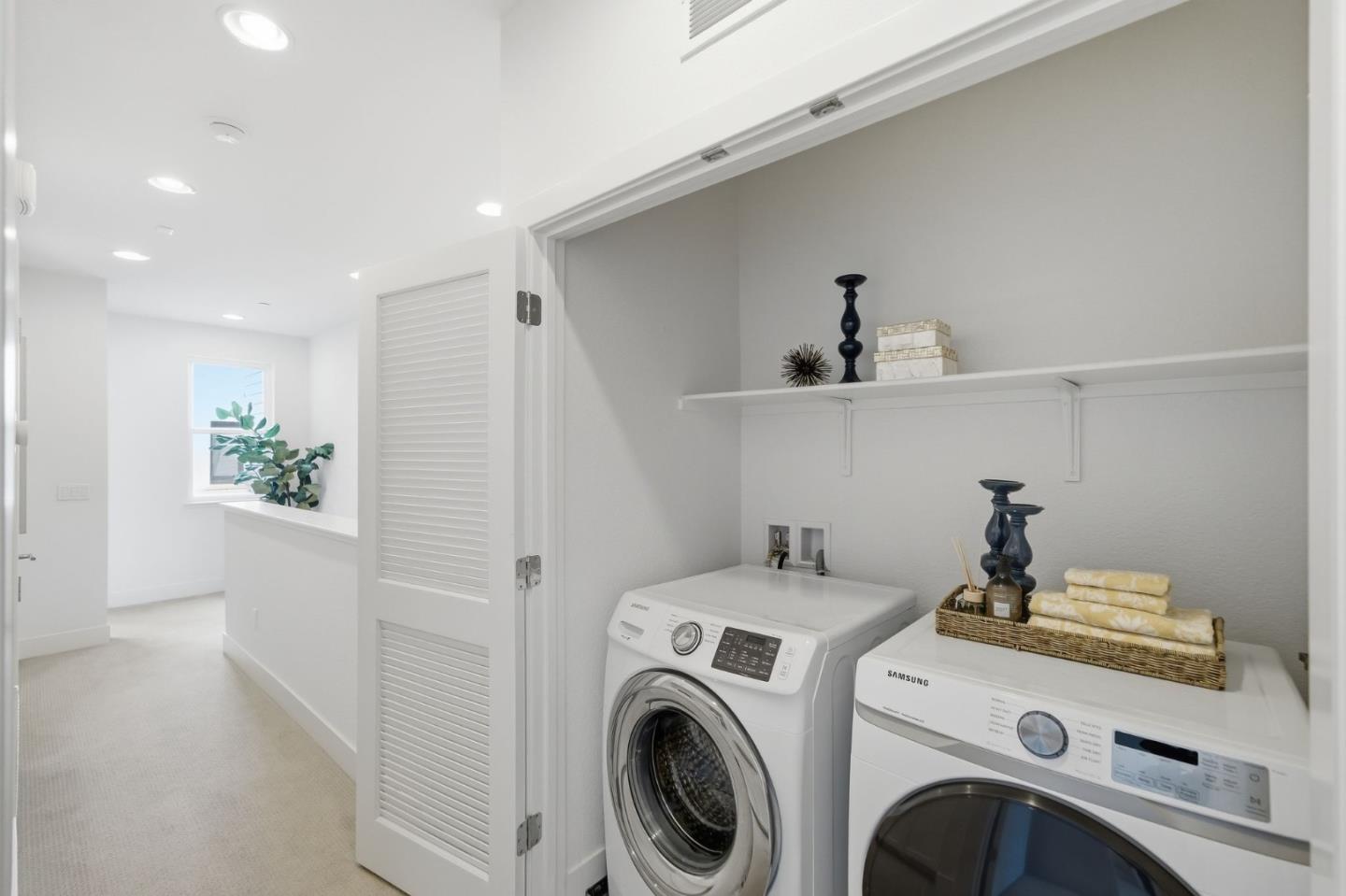 39124 Memorial Street Fremont, CA 94538 - Photo 34 of 40 a view of washer and dryer with kitchen in the background