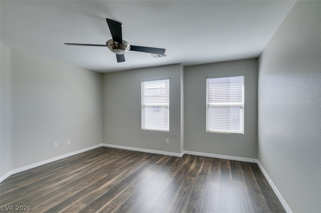 4650 Ranch House Road, Unit 46 North Las Vegas, NV 89031 - Photo 27 of 38 Rich wood-inspired flooring and clean white baseboards anchor this versatile bedroom space.
