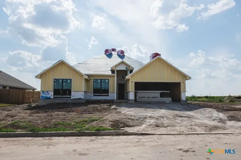 a view of a house with a yard and roof