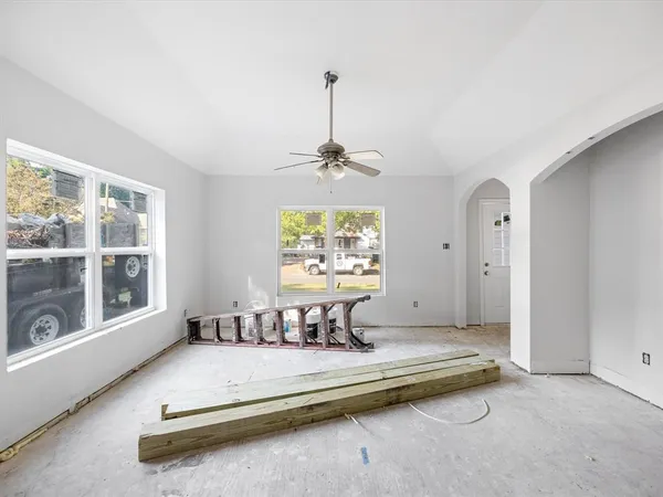 a view of a kitchen with white cabinets and wooden floor