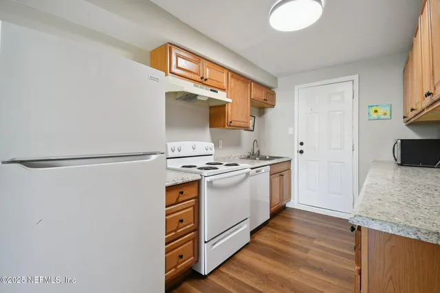a kitchen with stainless steel appliances granite countertop a stove and a refrigerator