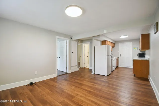 a view of a kitchen with a sink and a refrigerator