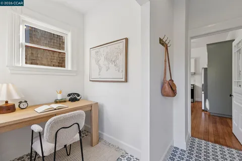 a view of a hallway with chairs and front door