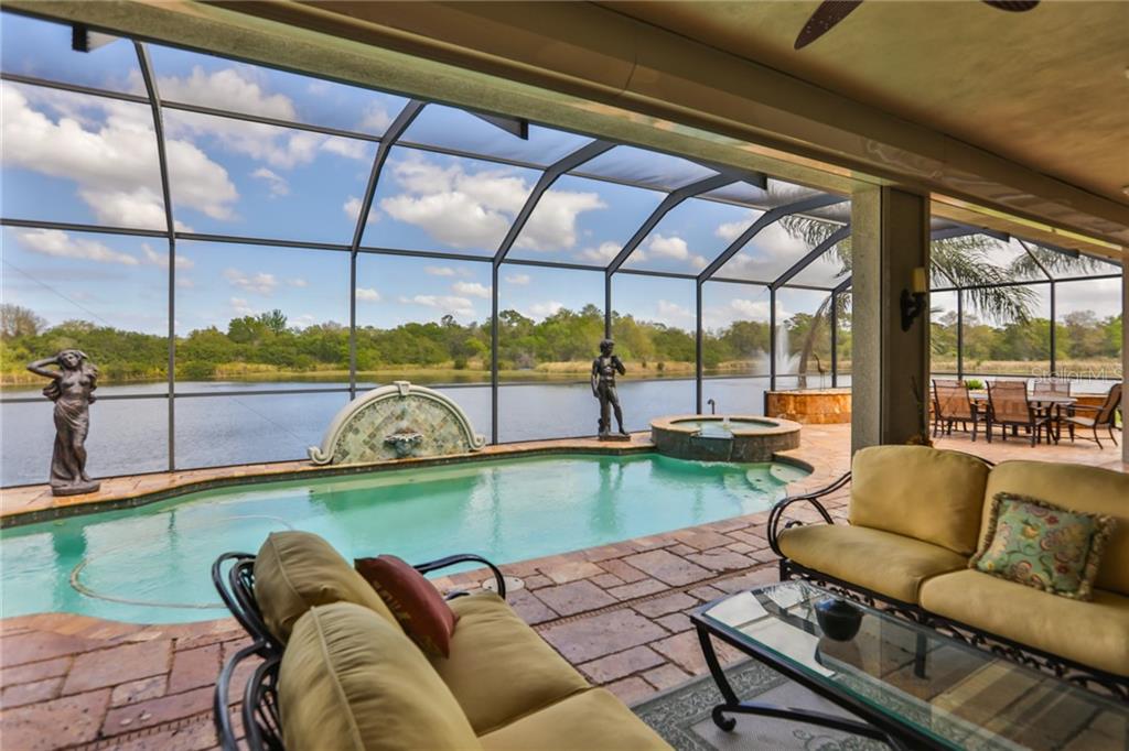 Florida sunshine, sea breezes and water fountains, this is Florida living at it's best!  Enjoy the pool, the spa and the wildlife in complete privacy and elegance, which even opens up to the home for easy entertainment and full relaxation!