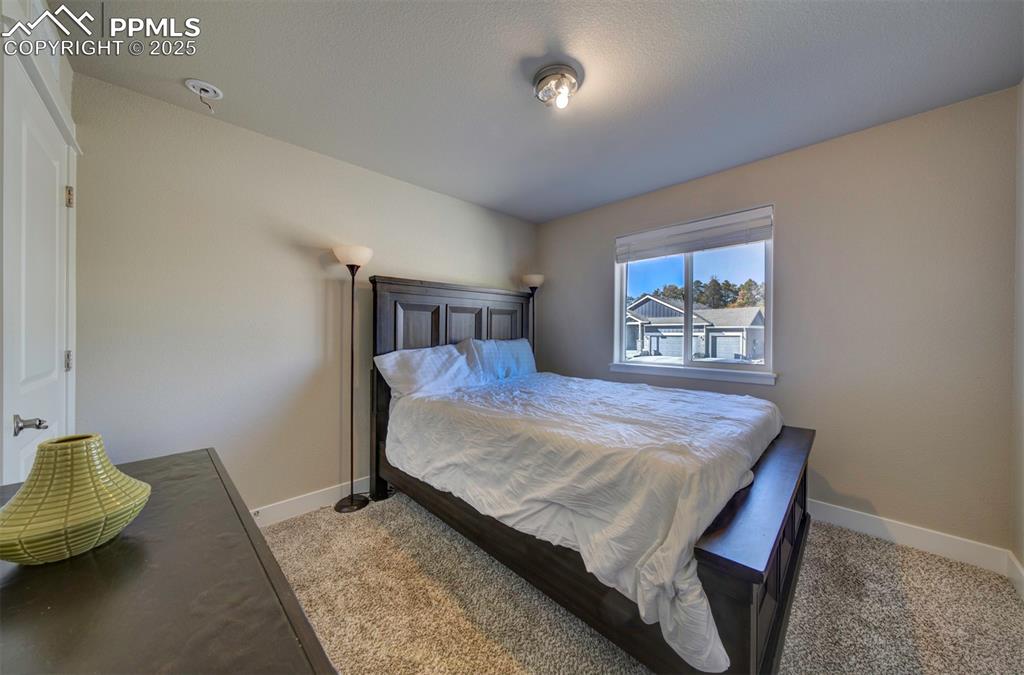 5489 Makalu Drive Colorado Springs, CO 80924 - Photo 11 of 47 a bedroom with a bed and painting on the wall