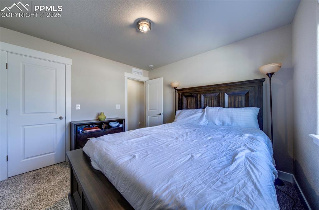 5489 Makalu Drive Colorado Springs, CO 80924 - Photo 12 of 47 a bed sitting in a bedroom and view of kitchen