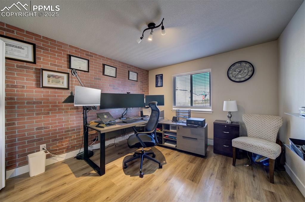 5489 Makalu Drive Colorado Springs, CO 80924 - Photo 15 of 47 a living room with furniture and a wooden floor