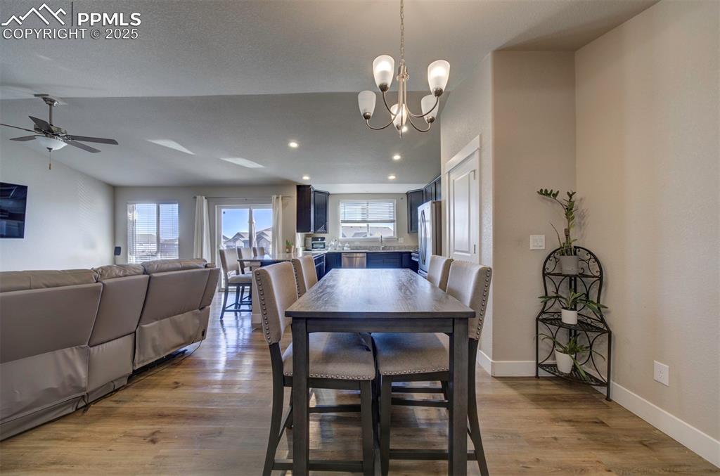 5489 Makalu Drive Colorado Springs, CO 80924 - Photo 16 of 47 a view of a dining room with furniture and wooden floor
