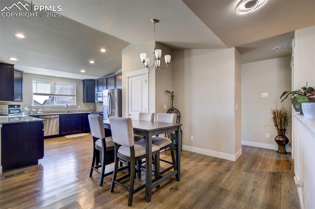 5489 Makalu Drive Colorado Springs, CO 80924 - Photo 19 of 47 a view of a dining room with furniture and wooden floor