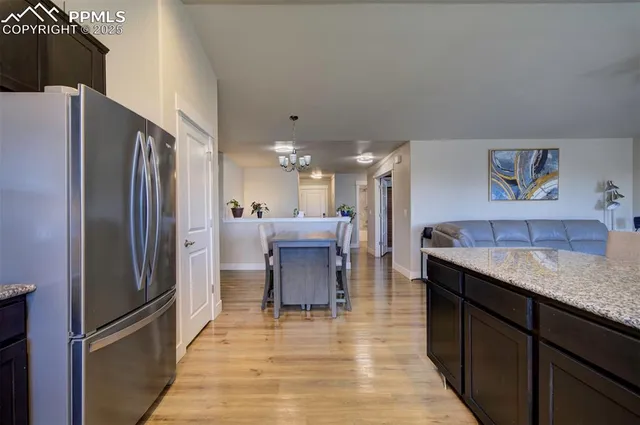 a kitchen with stainless steel appliances granite countertop a refrigerator and a sink