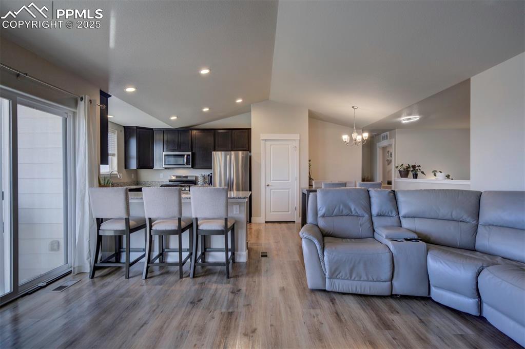 5489 Makalu Drive Colorado Springs, CO 80924 - Photo 24 of 47 a living room kitchen with furniture and a wooden floor