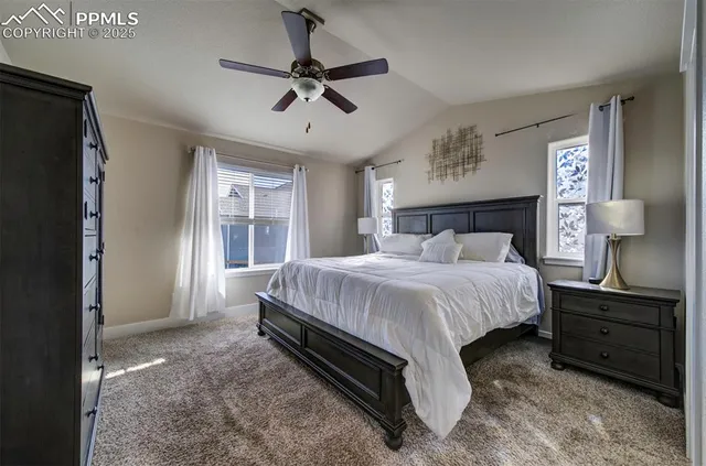 a spacious bedroom with a bed and a chandelier