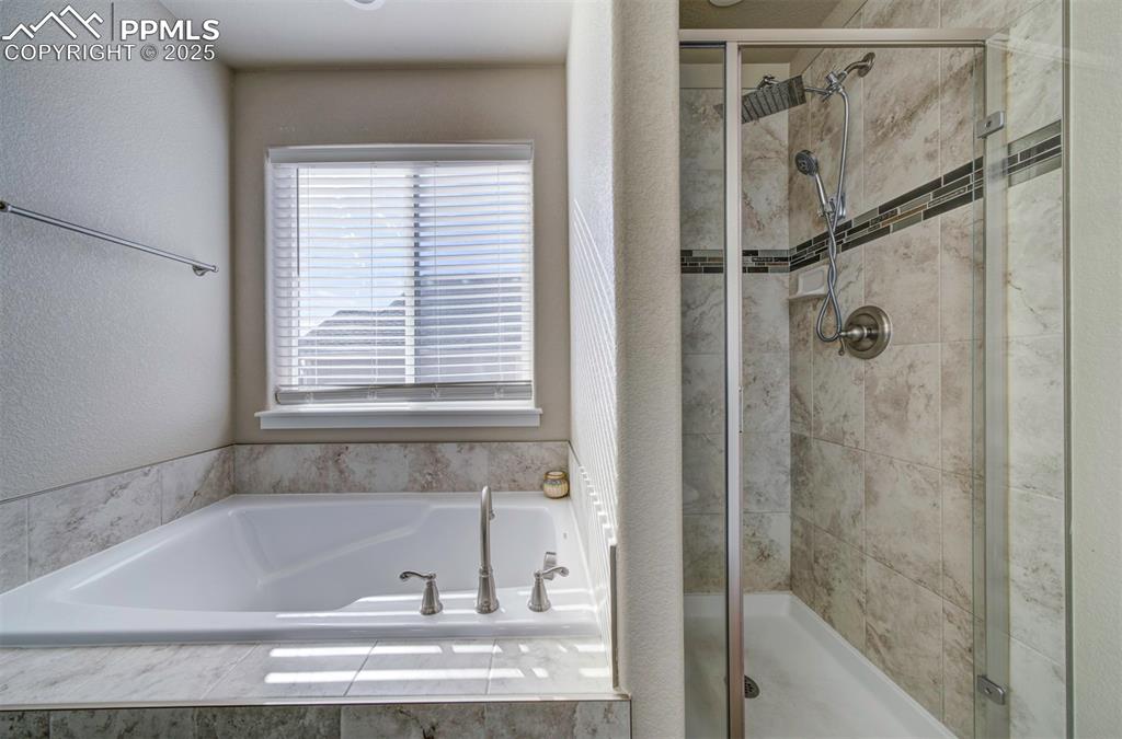 5489 Makalu Drive Colorado Springs, CO 80924 - Photo 31 of 47 a bathroom with a bathtub and a shower