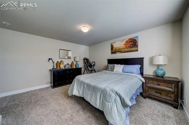a bedroom with a bed and a painting on the wall