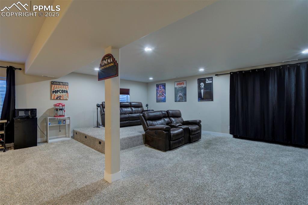 5489 Makalu Drive Colorado Springs, CO 80924 - Photo 37 of 47 a living room with furniture and a flat screen tv