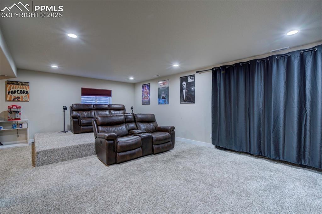 5489 Makalu Drive Colorado Springs, CO 80924 - Photo 40 of 47 a living room with furniture and a cabinet