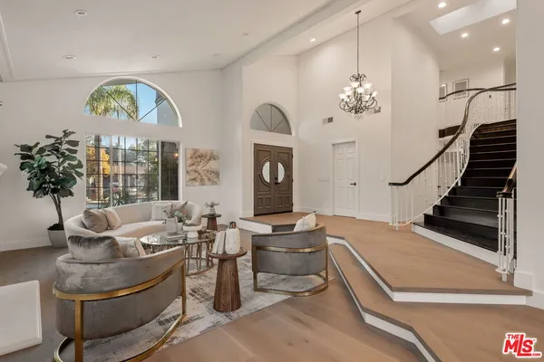 a living room with furniture chandelier and a chandelier