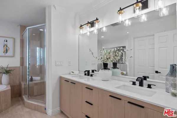 a bathroom with a sink double vanity and a shower