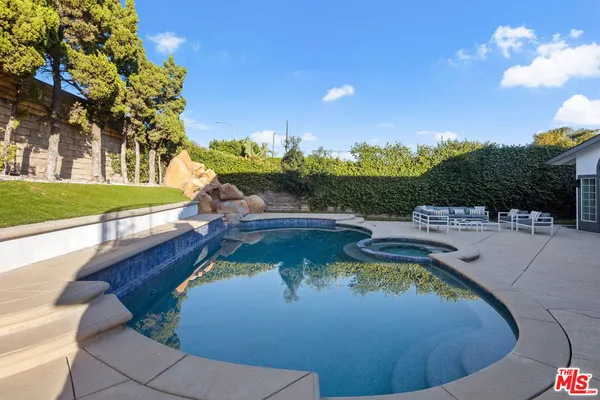 a view of a swimming pool with a yard