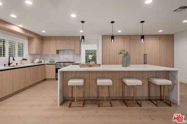 a large kitchen with a table and chairs in it