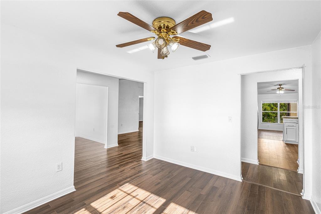 418 Windermere Drive Lehigh Acres, FL 33972 - Photo 17 of 71 a view of an empty room with wooden floor