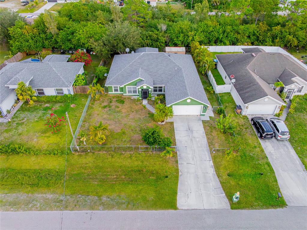 418 Windermere Drive Lehigh Acres, FL 33972 - Photo 2 of 71 an aerial view of residential houses with outdoor space