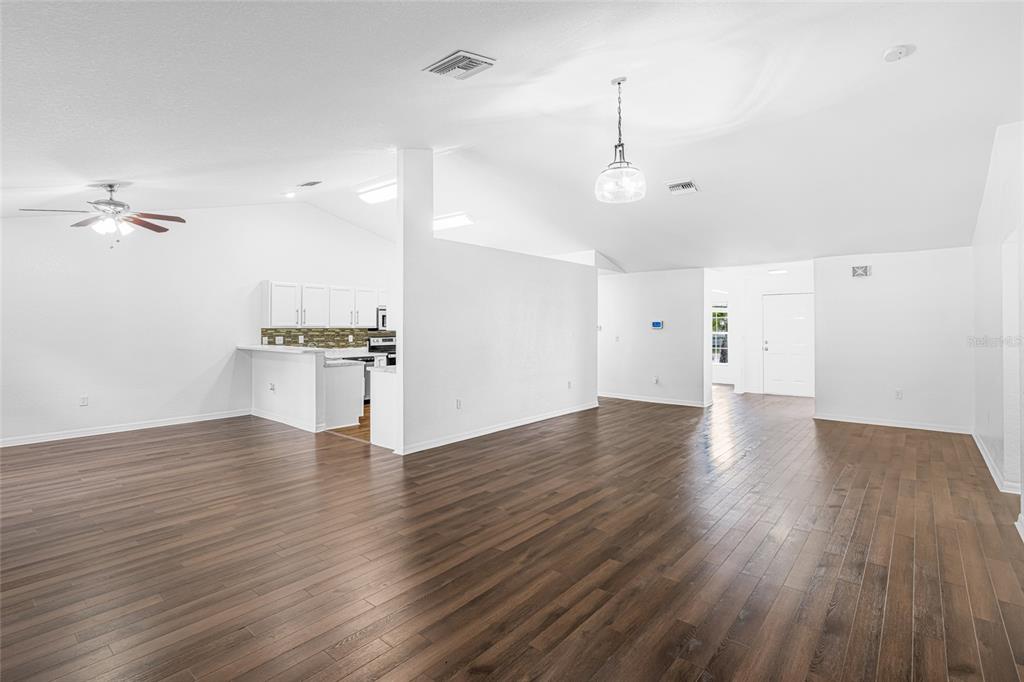 418 Windermere Drive Lehigh Acres, FL 33972 - Photo 21 of 71 wooden floor in an empty room with a window
