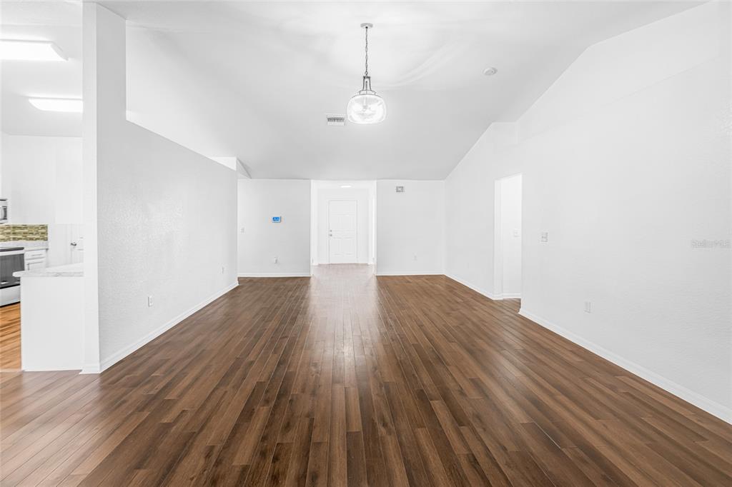 418 Windermere Drive Lehigh Acres, FL 33972 - Photo 23 of 71 a view of a room with wooden floor and window