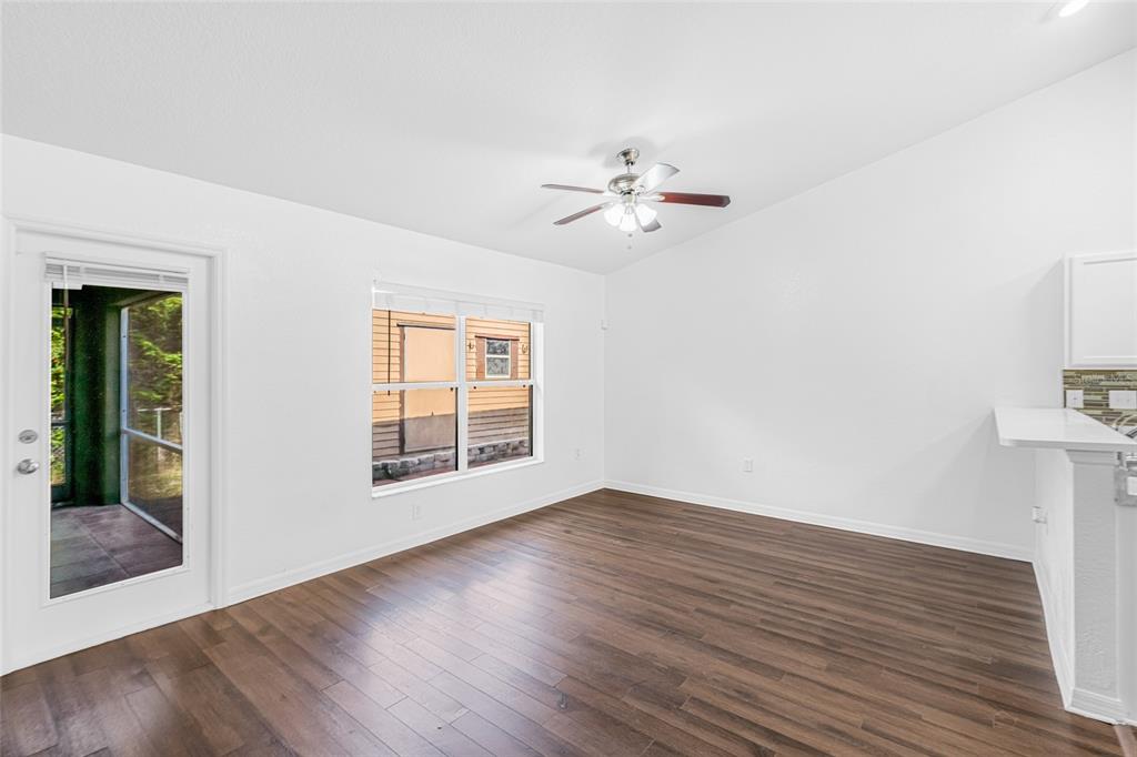 418 Windermere Drive Lehigh Acres, FL 33972 - Photo 24 of 71 a view of an empty room with glass door and wooden floor
