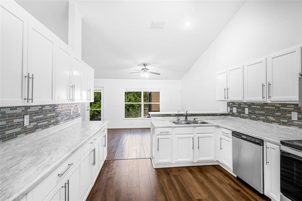 418 Windermere Drive Lehigh Acres, FL 33972 - Photo 29 of 71 a kitchen with a sink stove and cabinets