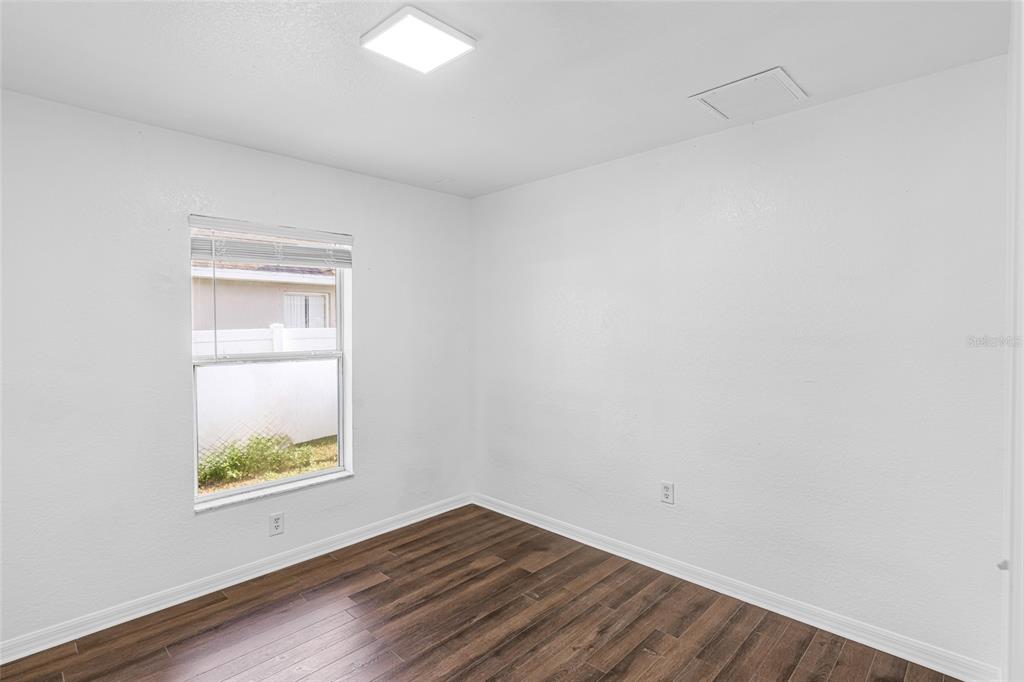 418 Windermere Drive Lehigh Acres, FL 33972 - Photo 34 of 71 a view of room with window and wooden floor