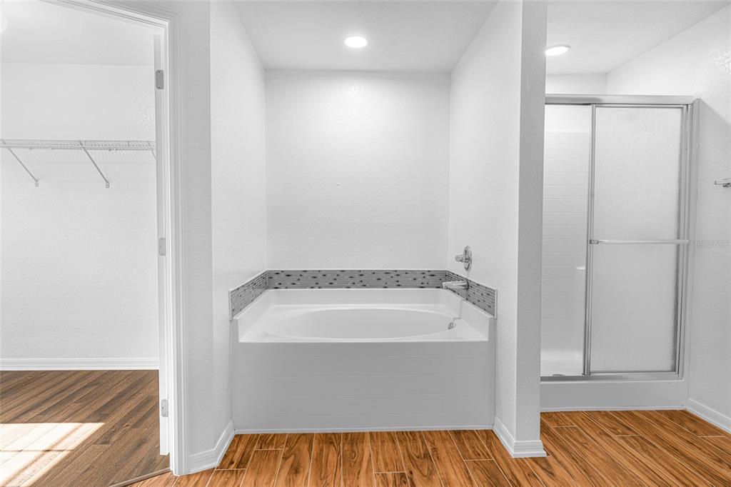 418 Windermere Drive Lehigh Acres, FL 33972 - Photo 47 of 71 a bathroom with a tub and shower