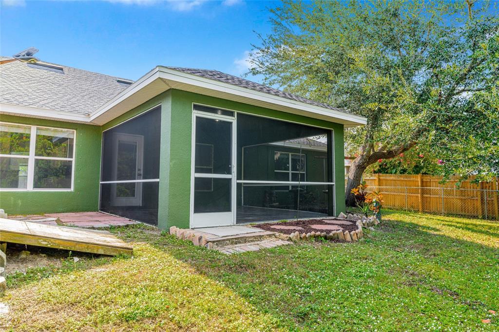 418 Windermere Drive Lehigh Acres, FL 33972 - Photo 52 of 71 a backyard of a house with yard table and chairs