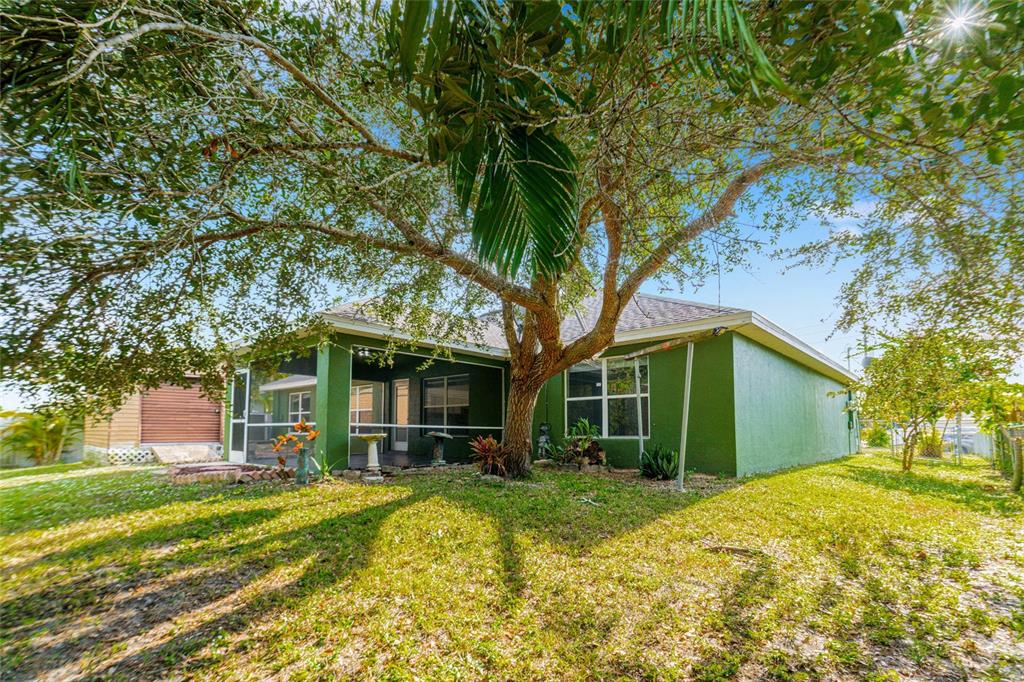418 Windermere Drive Lehigh Acres, FL 33972 - Photo 54 of 71 a view of a house with a yard
