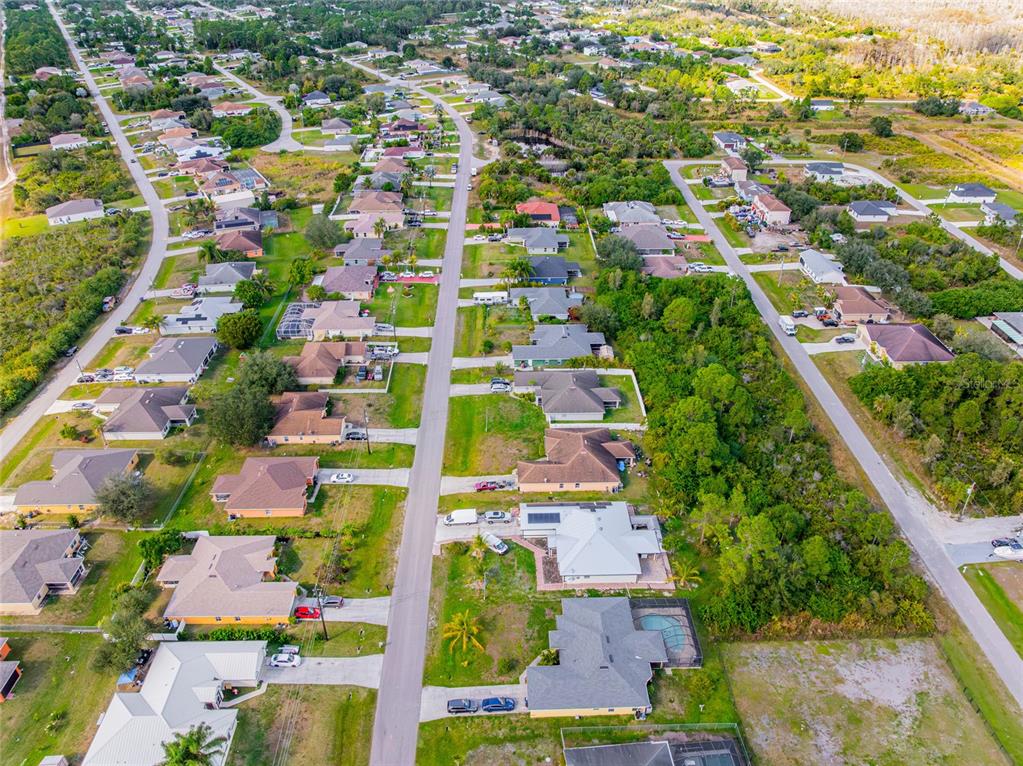 418 Windermere Drive Lehigh Acres, FL 33972 - Photo 65 of 71 an aerial view of residential houses with outdoor space
