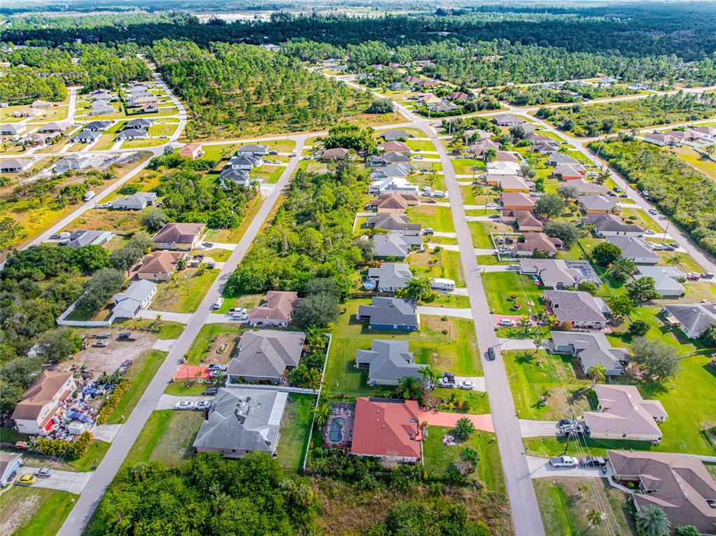418 Windermere Drive Lehigh Acres, FL 33972 - Photo 69 of 71 an aerial view of residential houses with outdoor space and street view