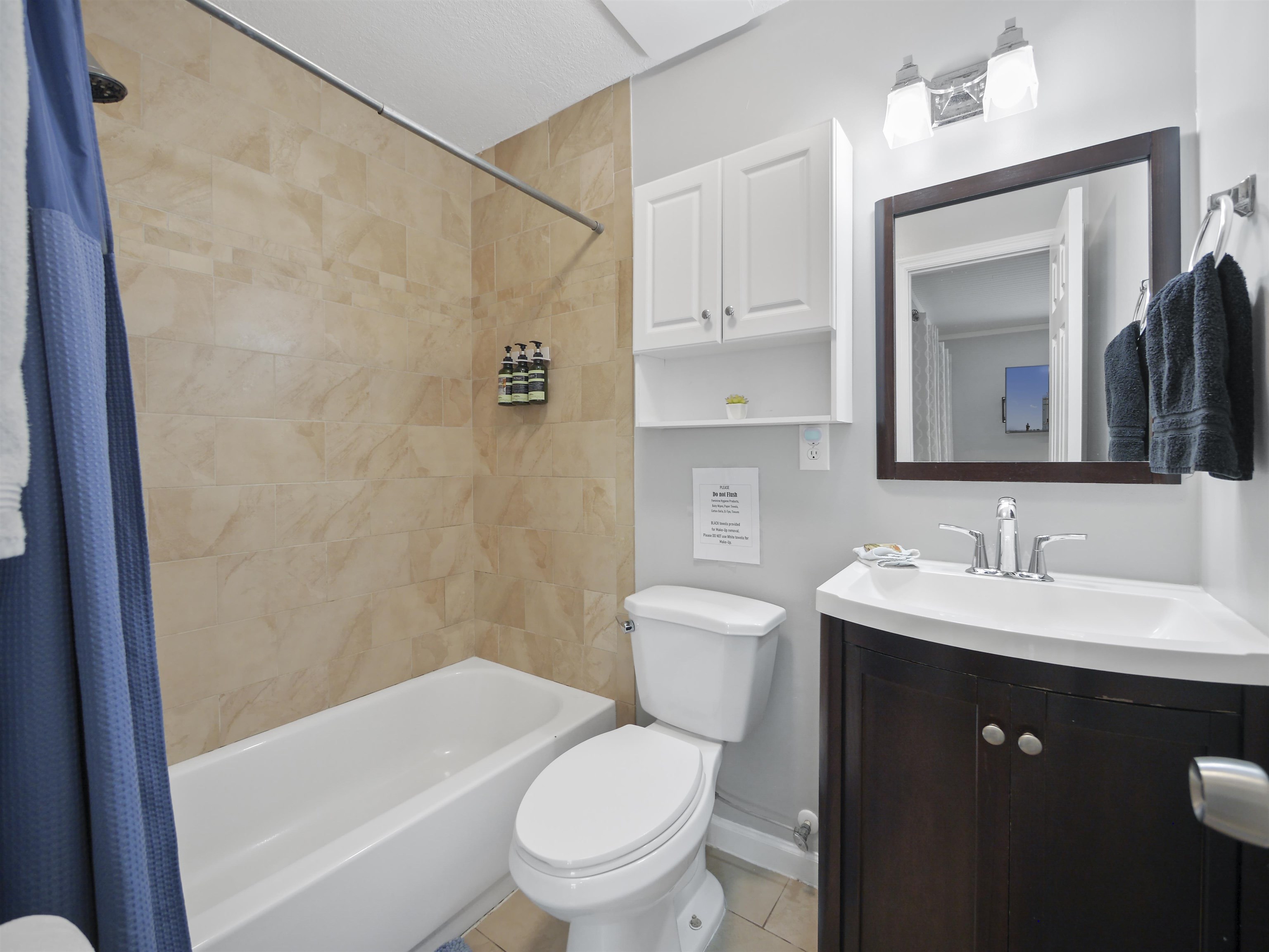 241 Tropic Way St. Augustine, FL 32080 - Photo 17 of 32 a bathroom with a toilet a sink a vanity and mirror