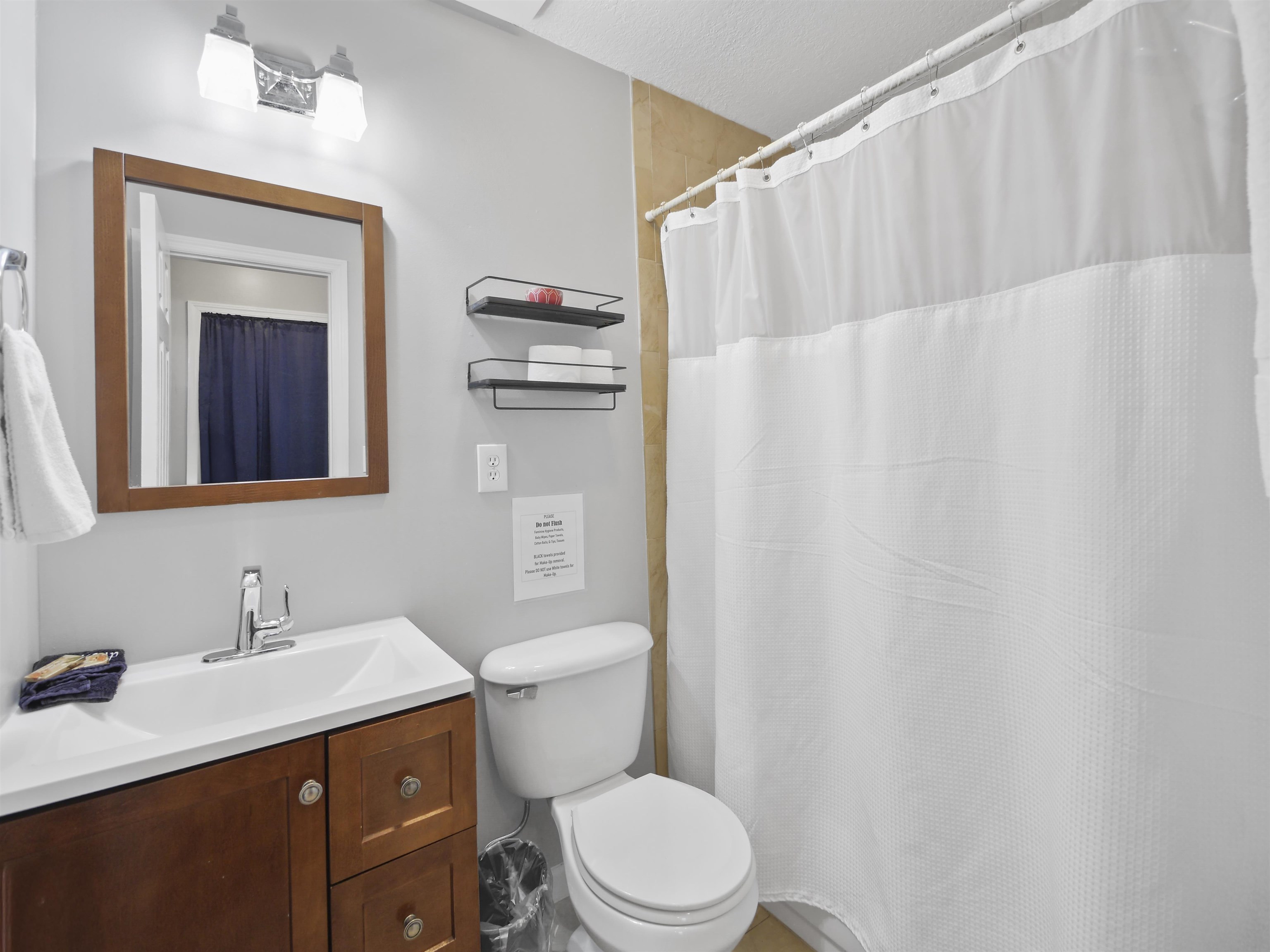 241 Tropic Way St. Augustine, FL 32080 - Photo 21 of 32 a bathroom with a sink a toilet and shower curtain