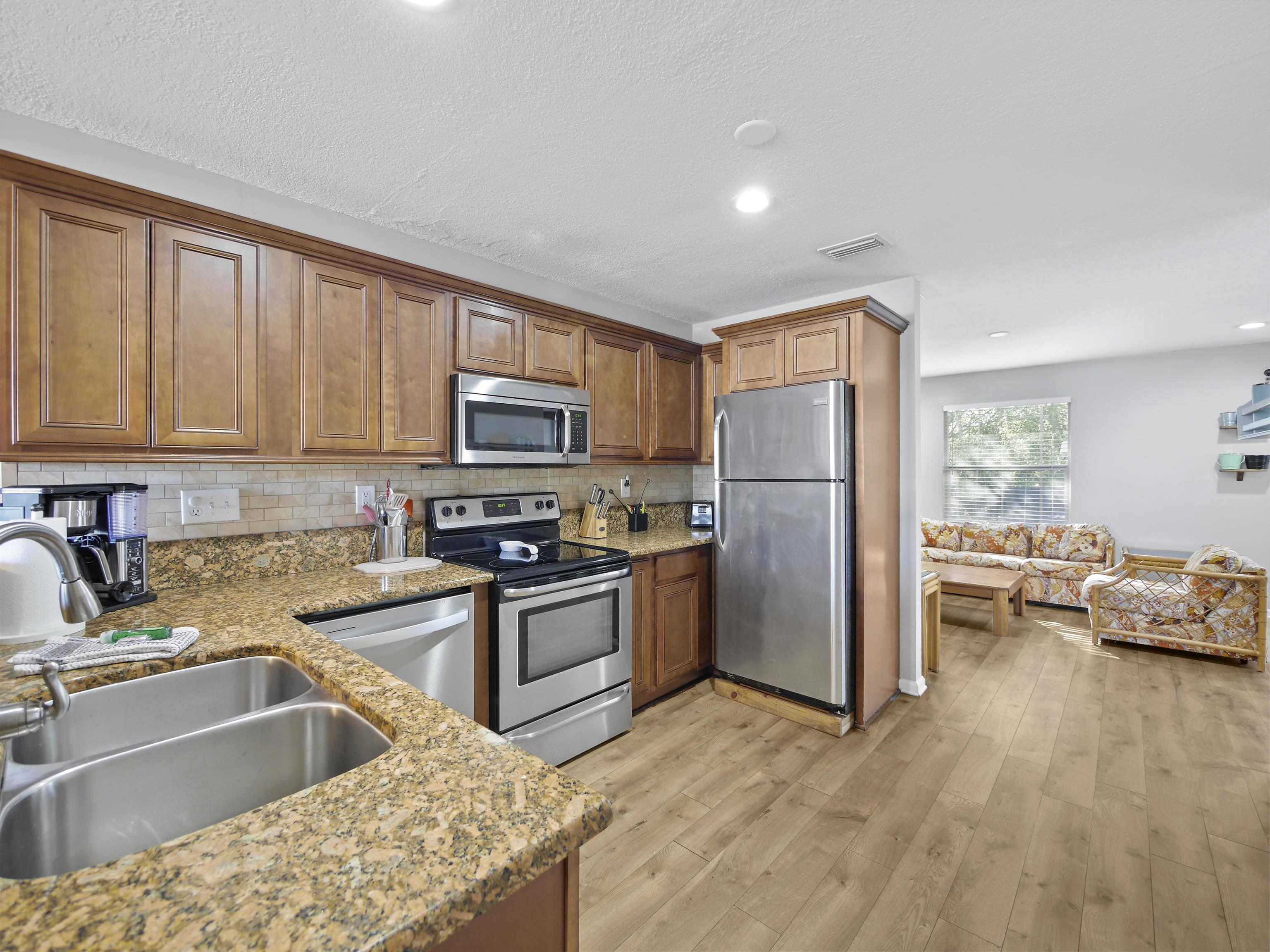 241 Tropic Way St. Augustine, FL 32080 - Photo 10 of 32 a kitchen with stainless steel appliances granite countertop a refrigerator stove top oven and sink