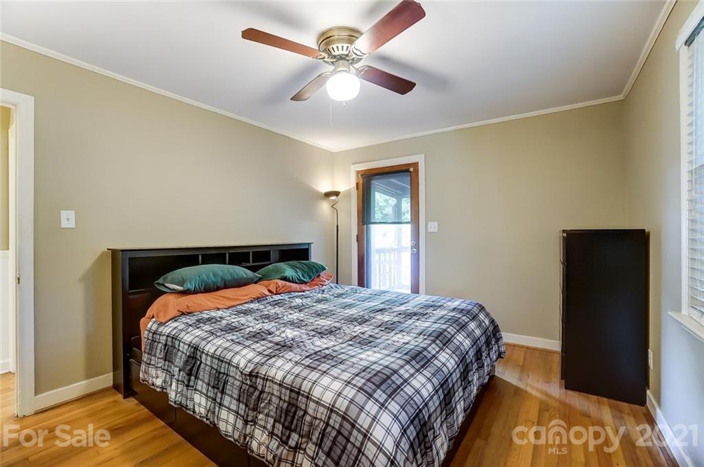 4460 Applegate Road Charlotte, NC 28209 - Photo 17 of 41 a bedroom with a bed and a chandelier